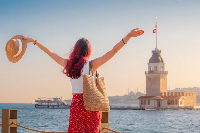 A woman with red hair holds a straw hat with her arms outstretched, looking out from the shore towards the Maiden\\\\\\\\\\\\\\\\\\\\\\\\\\\\\\\\\\\\\\\\\\\\\\\\\\\\\\\\\\\\\\\\\\\\\\\\\\\\\\\\\\\\\\\\\\\\\\\\\\\\\\\\\\\\\\\\\\\\\\\\\\\\\\\\\\\\\\\\\\\\\\\\\\\\\\\\\\\\\\\\\\\\\\\\\\\\\\\\\\\\\\\\\\\\\\\\\\\\\\\\\\\\\\\\\\\\\\\\\\\\\\\\\\\\\\\\\\\\\\\\\\\\\\\\\\\\\\\'s Tower on the Bosphorus strait in Istanbul.
