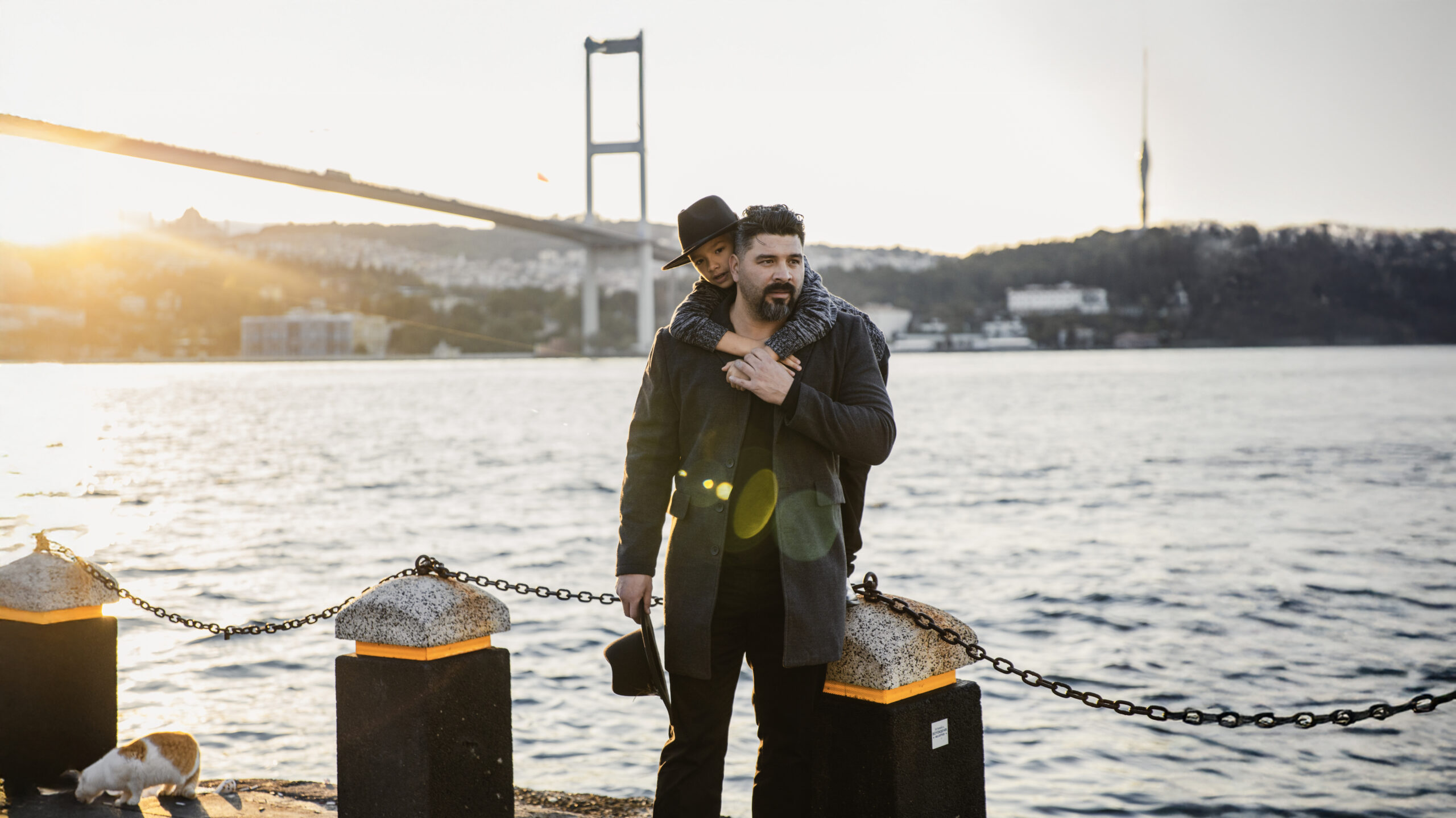 Father and son photography in Ortakoy, Istanbul with a view of the Bosphorus Bridge