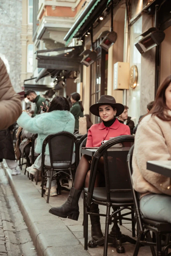 Street cafe scene with a woman seated along a narrow Galata street Istanbul - turkey
