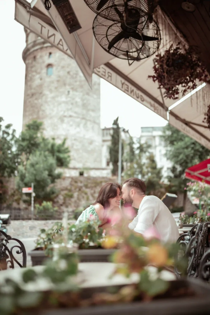 Romantic couple sitting at a cafe around Galata tower Istanbul turkey