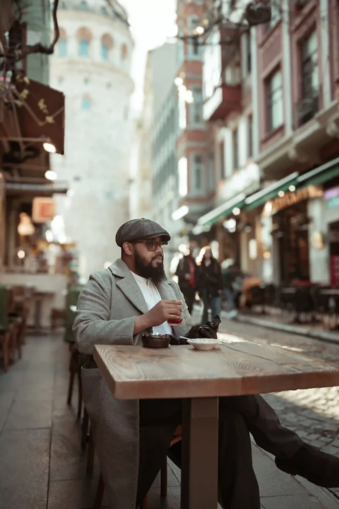 man sitting at a street cafe table in Galata - Istanbul - turkey