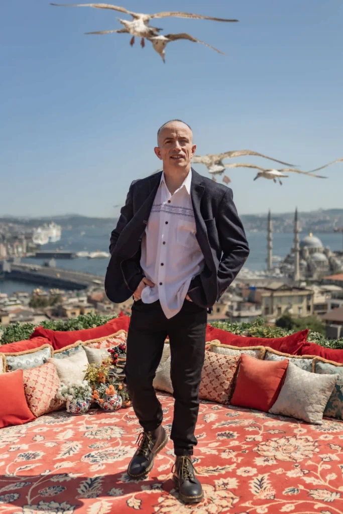male poses in Istanbul, tourist posing on rooftop in Fatih with seagulls and mosque view