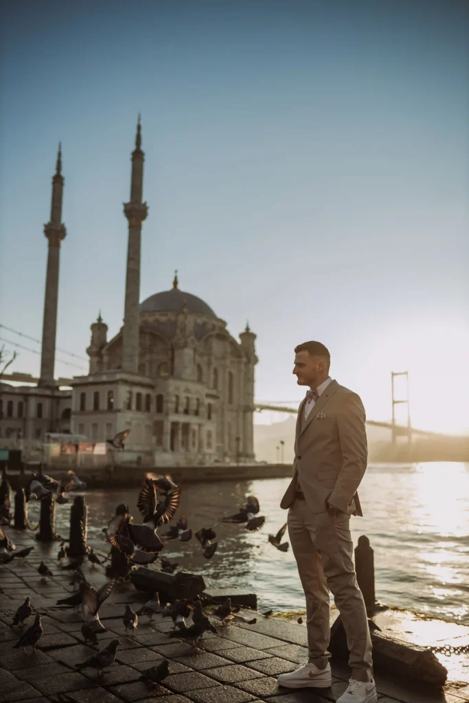 male poses in Istanbul, elegant standing pose in suit at Ortaköy Mosque at sunrise